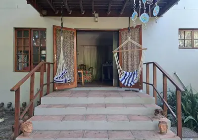 a house with two hammocks on the front porch at Apple Pie Self-catering in Hermanus