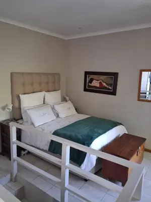 a white bed in a room with acknowled at Apple Pie Self-catering in Hermanus
