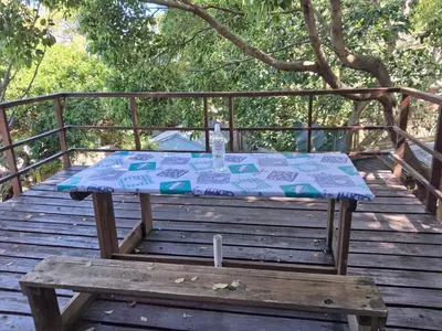 a picnic table sitting on a wooden deck at Apple Pie Self-catering in Hermanus