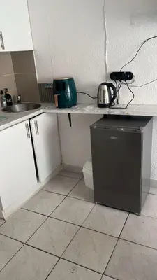 a kitchen with a counter with a sink and a dishwasher at 12 on lake Grassy Park in Parkwood