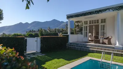 a house with a yard with a swimming pool at Lily Pond House at Le Lude in Franschhoek