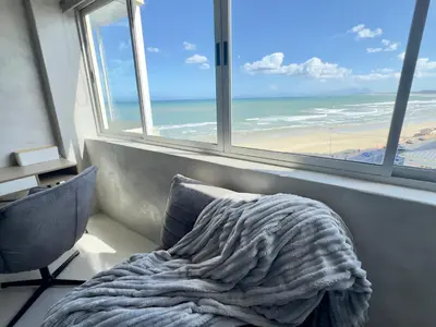 a bed in a room with a view of the ocean at Casa Praia in Strand