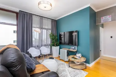 a living room with a couch and a tv at Burmeister Circle by CTHA in Cape Town