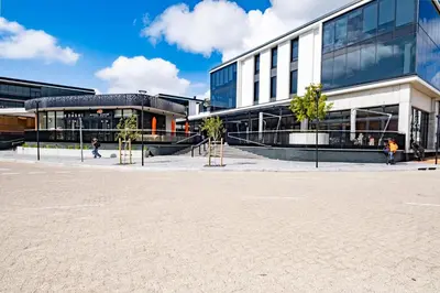a large building with trees in front of it at Riverlands - Lux 1 bedroom Apartment with Parking in Cape Town