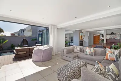 a living room with a couch and chairs at Ocean Whisper Terrace Villa in Cape Town