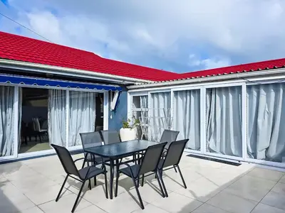 a black dining table and chairs on a balcony at Elianta House in Cape Town