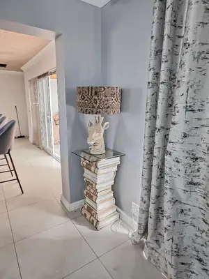 a room with a stack of books and a vase on a table at Elianta House in Cape Town