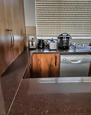 a kitchen with a counter top and a dishwasher at Elianta House in Cape Town