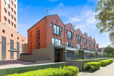 an office building with a red brick facade at Manhattan Wharfside 301 in Cape Town