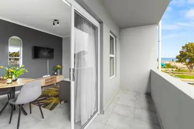 a dining room with a table and a view of the ocean at The Orion 18 in Table View