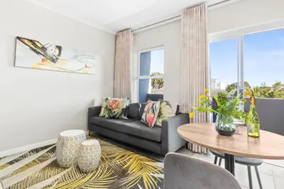 a living room with a couch and a table at The Orion 18 in Table View