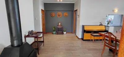 a living room with a table and a stove at 25 on Union in Strand