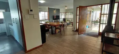 a kitchen and dining room with a table and chairs at 25 on Union in Strand