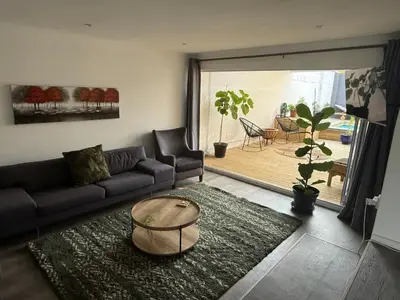 a living room with a couch and a table at Mopanie House in Brackenfell