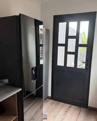 a black door with a window in a room at Mopanie House in Brackenfell