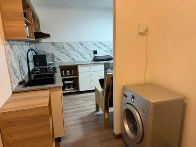 a kitchen with a washing machine in a kitchen at Mopanie House in Brackenfell