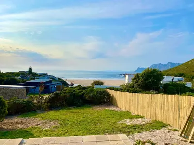 a view of the beach from a fence at Sea and Sky Rooiels in Rooiels