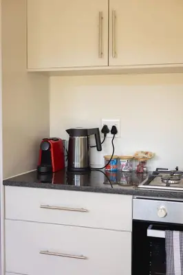 a kitchen counter with a coffee pot on it at Valley's Embrace Apartment 7 in Hermanus
