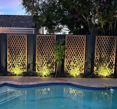 a fence with a swimming pool with lights on it at Shire Lodge in Cape Town
