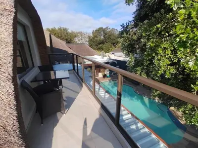 a balcony with a view of a swimming pool at Shire Lodge in Cape Town