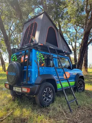 a blue jeep with a camper on top of it at Happy Campers South Africa in Strand