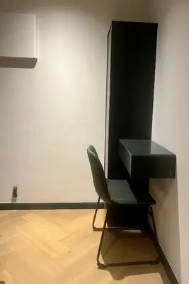 a black desk and a chair in a room at The CoziPlace Lux in Cape Town