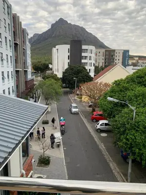 a city street with a mountain in the background at Treetops Studio in Cape Town