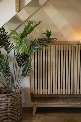 a wooden bench with three plants on the wall at Aurora Valley Escape Apartment 9 in Hermanus