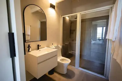 a bathroom with a toilet and a sink and a shower at Aurora Valley Escape Apartment 9 in Hermanus