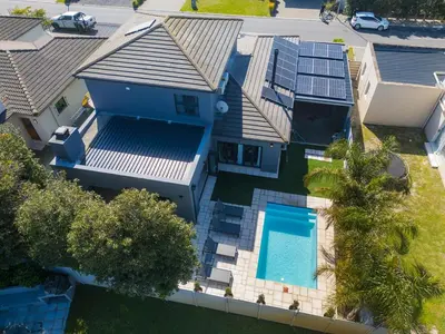 an overhead view of a house with a swimming pool at Peppertree Villa in Brackenfell