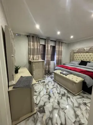 a bedroom with a bed with a red comforter at Luxurious Family Home 2
