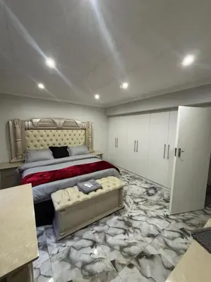 a bedroom with a bed and a couch in it at Luxurious Family Home 2