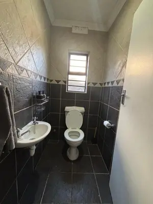 a bathroom with a toilet and a sink at Luxurious Family Home 2