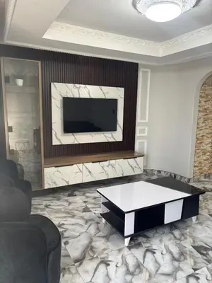 a living room with a television and a coffee table at Luxurious Family Home 2