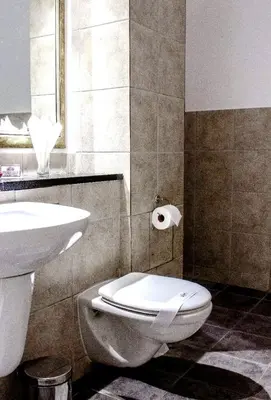 a bathroom with a white toilet and a sink at The Strand Pavilion Gordon's Bay in Strand
