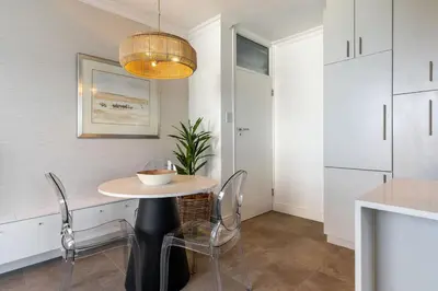 a dining room with a table and chairs in a kitchen at Modern 1 Bedroom Table Mountain View Hideaway, Milnerton in Cape Town