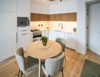 a kitchen with a wooden table and chairs at Charming Apartment in Cape Winelands District in Stellenbosch