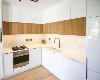 a kitchen with white cabinets and a sink and a stove at Charming Apartment in Cape Winelands District in Stellenbosch