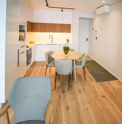 a kitchen and dining room with a table and chairs at Charming Apartment in Cape Winelands District in Stellenbosch