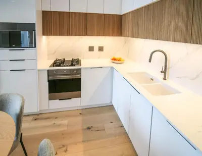 a kitchen with white counters and a sink at Charming Apartment in Cape Winelands District in Stellenbosch