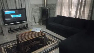 a living room with a couch and a tv at Schubert Self Catering Accomodation in Brackenfell