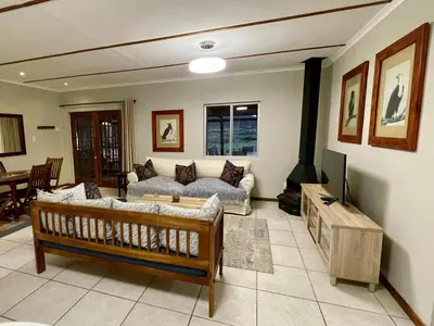 a living room with a couch and a tv at Rivergrace Farm in Robertson