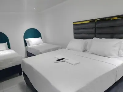 a bedroom with two beds and a chair at Guest Lodge on 12 Duminy in Bellville