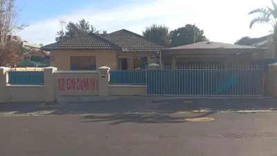a house with a blue fence in front of it at Guest Lodge on 12 Duminy in Bellville