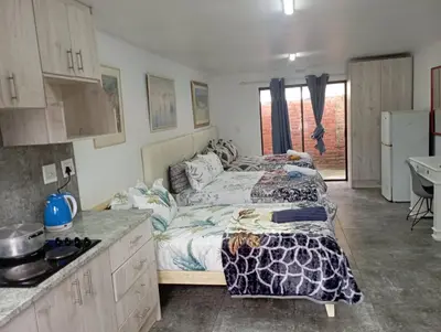 a bedroom with a bed in the middle of a kitchen at 8 Botha Goodwood the trout lodge in Elsiesrivier
