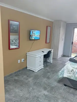 a bedroom with a white desk and a bed at 8 Botha Goodwood the trout lodge in Elsiesrivier