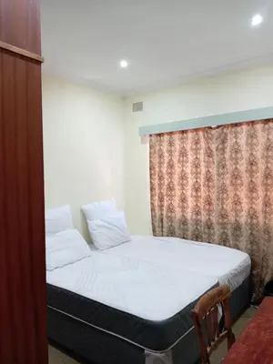 a bedroom with a bed and a window at Beyond Expectation in Avondale