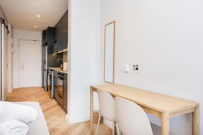 a kitchen and dining room with a wooden table and chairs at Paarl Superior Studio 230 With Onsite Parking in Paarl