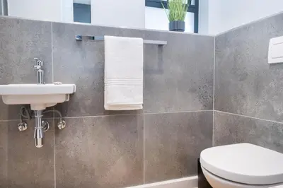 a bathroom with a toilet and a sink at Paarl Superior Studio 230 With Onsite Parking in Paarl