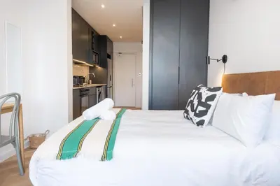 a bedroom with a large white bed with pillows at Paarl Superior Studio 231 - With Onsite Parking & Comforts in Paarl